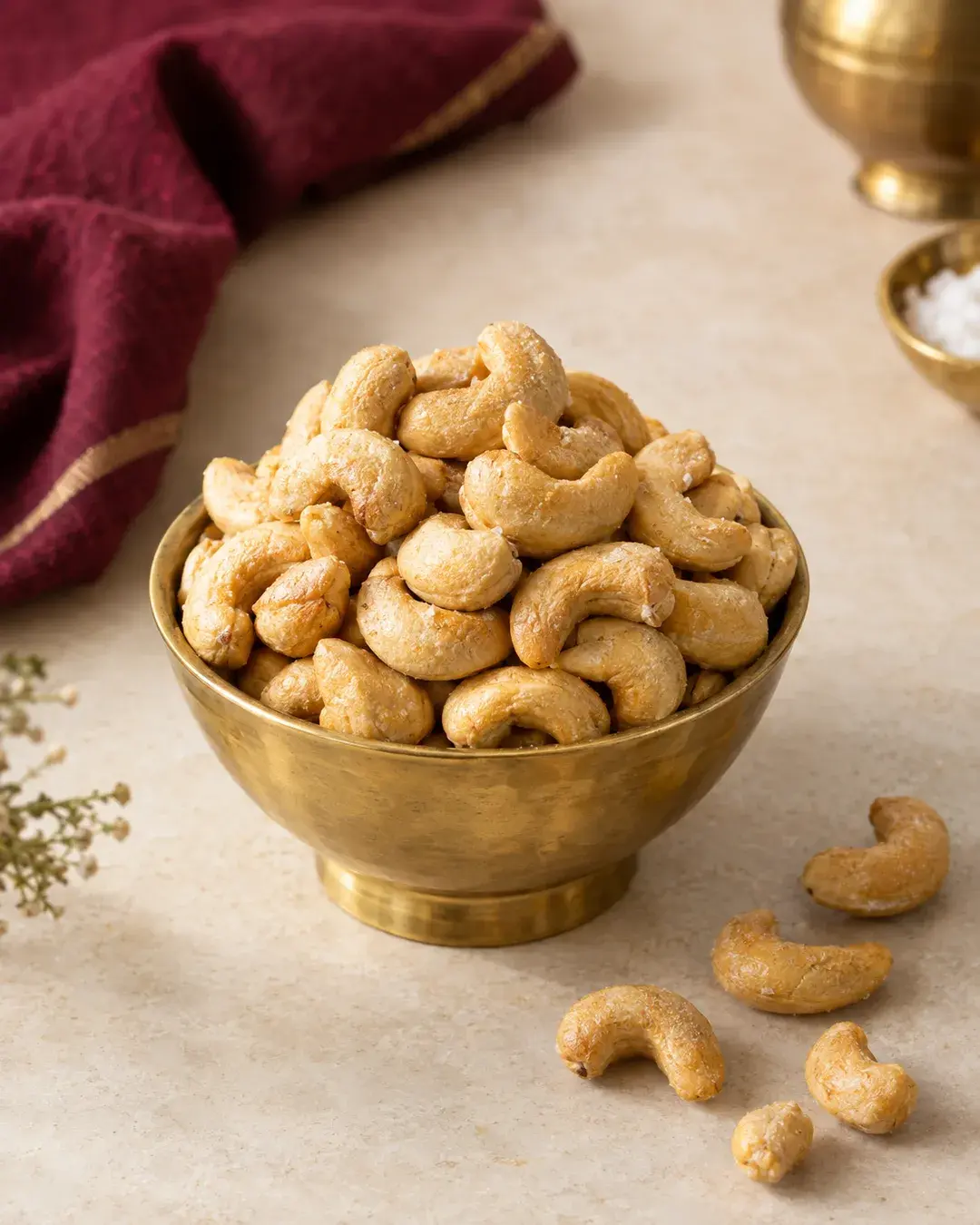 Lightly salted roasted cashews heaped in a kansa bowl